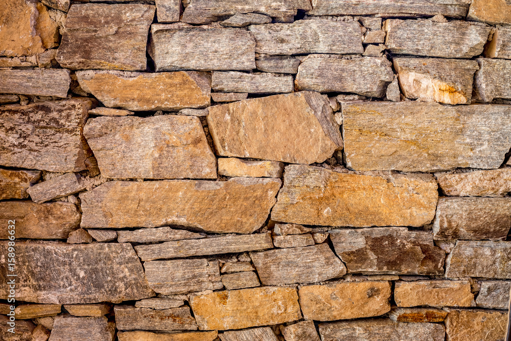 Stone wall with randomly shaped stones Stone wall with randomly shaped stones