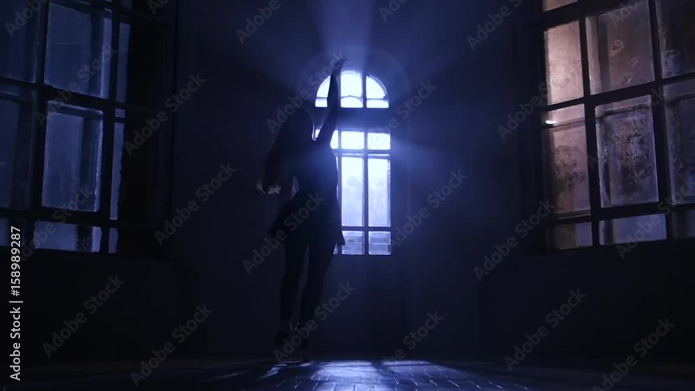 Graceful girl practicing ballet in studio, moonlight silhouette. Slow motion Graceful girl practicing ballet in studio, moonlight silhouette. Slow motion