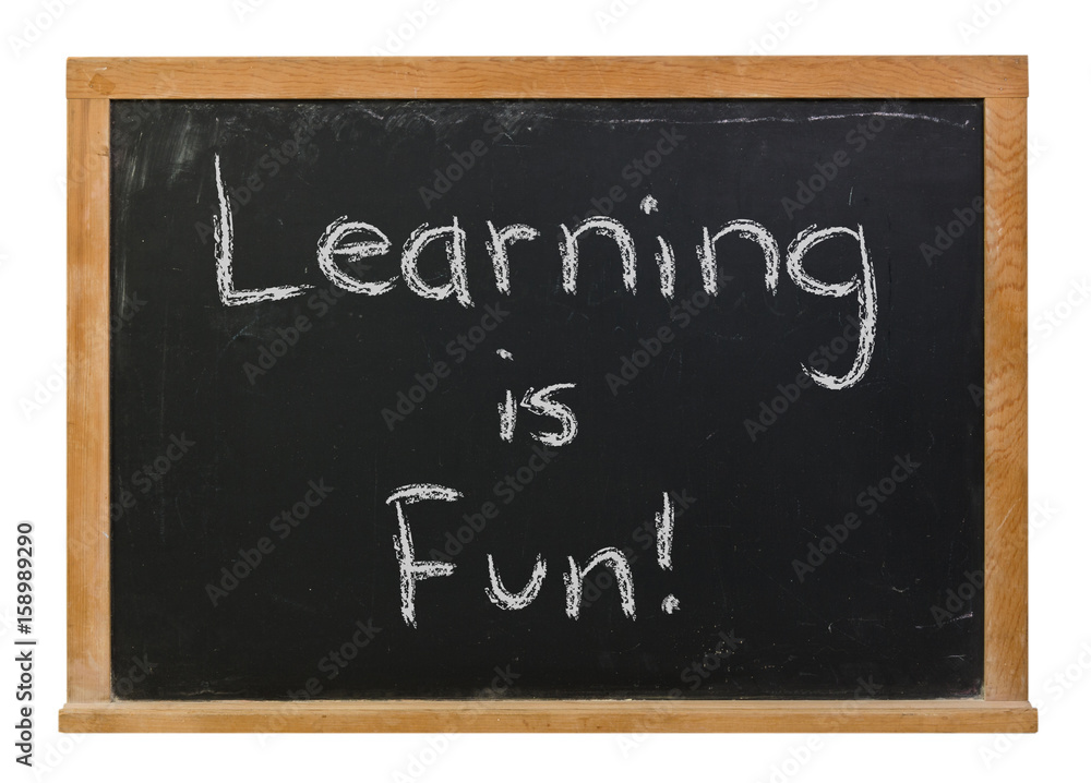 Fototapeta premium Learning is Fun written in white chalk on a black chalkboard isolated on white