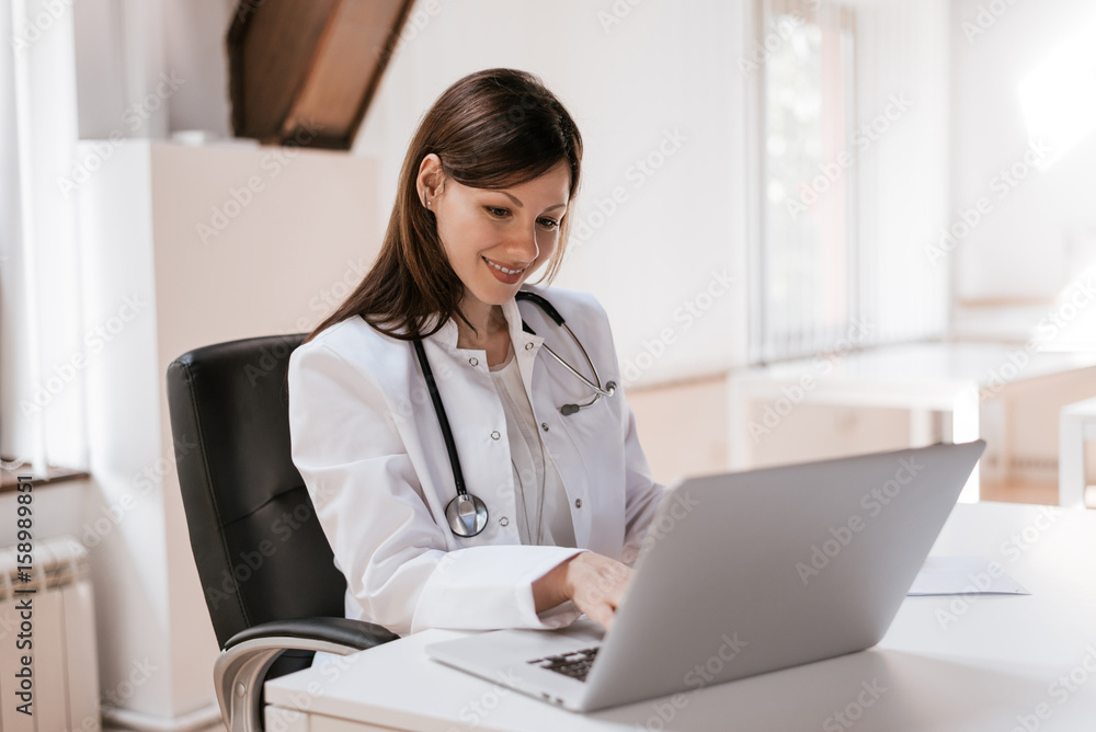 Female doctor at work using laptop Female doctor at work using laptop