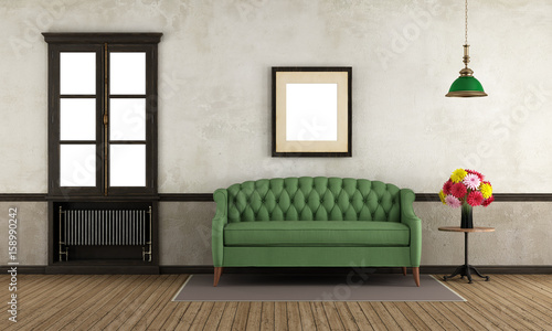 Empty retro room with green sofa and window