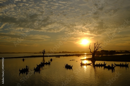 Silhouettes Boating man on river at Burma in sunset time