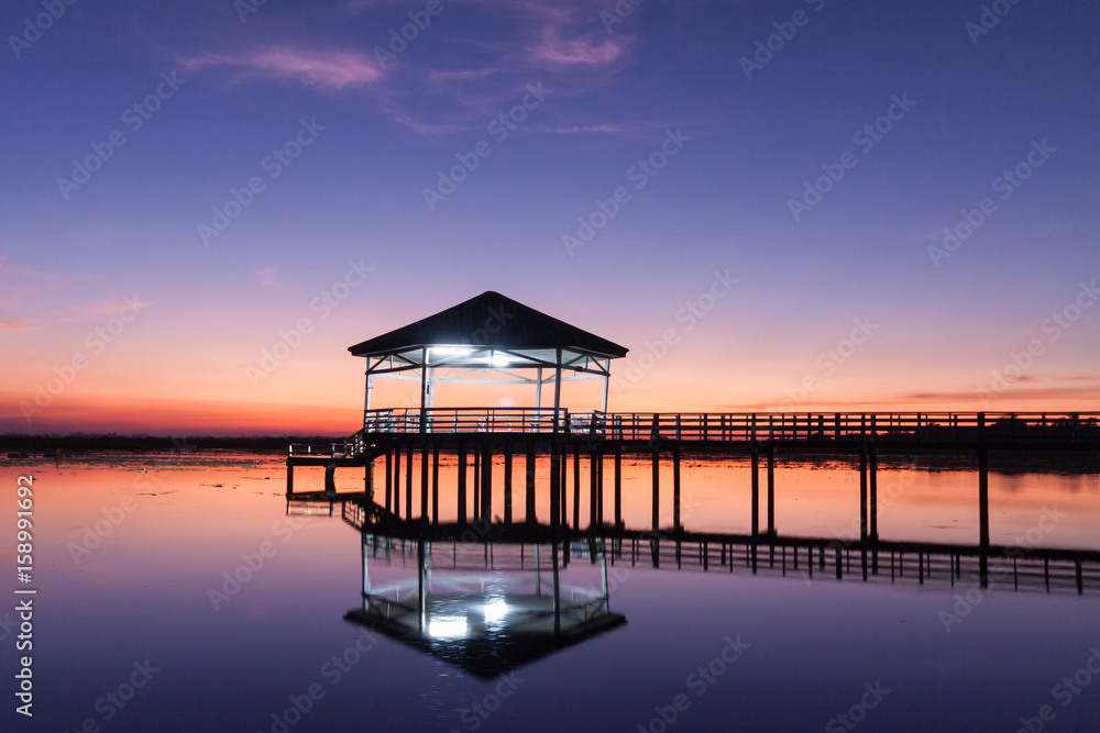 Sunset, Twilight at the reservoir with pavilion,Silhouette.(Bueng Si Fai Phichit.) Sunset, Twilight at the reservoir with pavilion,Silhouette.(Bueng Si Fai Phichit.)