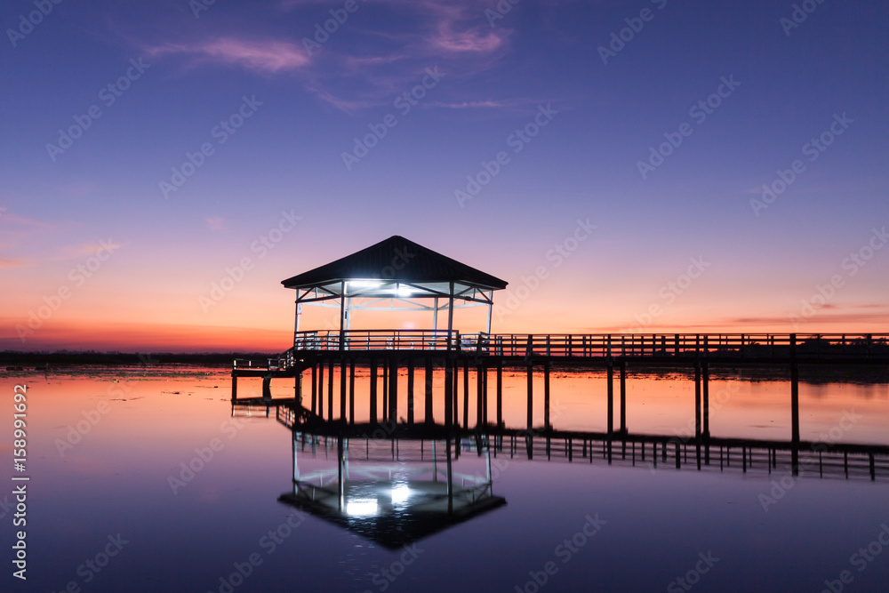 Sunset, Twilight at the reservoir with pavilion,Silhouette.(Bueng Si Fai Phichit.)