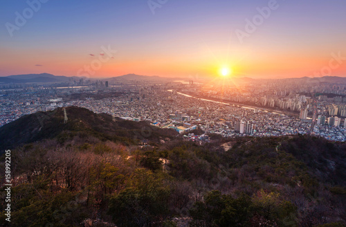 Seoul City and skyline with skyscrapers in Sunset, Han river in Aerial view of Yongma Mountain or Yongmasan photo