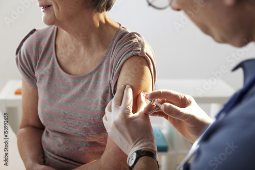 Vaccinating an elderly person photo
