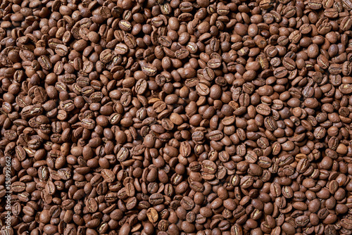 Roasted brown coffee beans, top view background