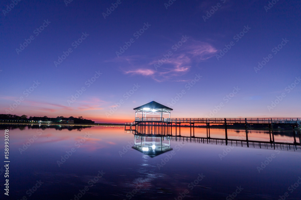 Sunset, Twilight at the reservoir with pavilion,Silhouette.(Bueng Si Fai Phichit.) Sunset, Twilight at the reservoir with pavilion,Silhouette.(Bueng Si Fai Phichit.)