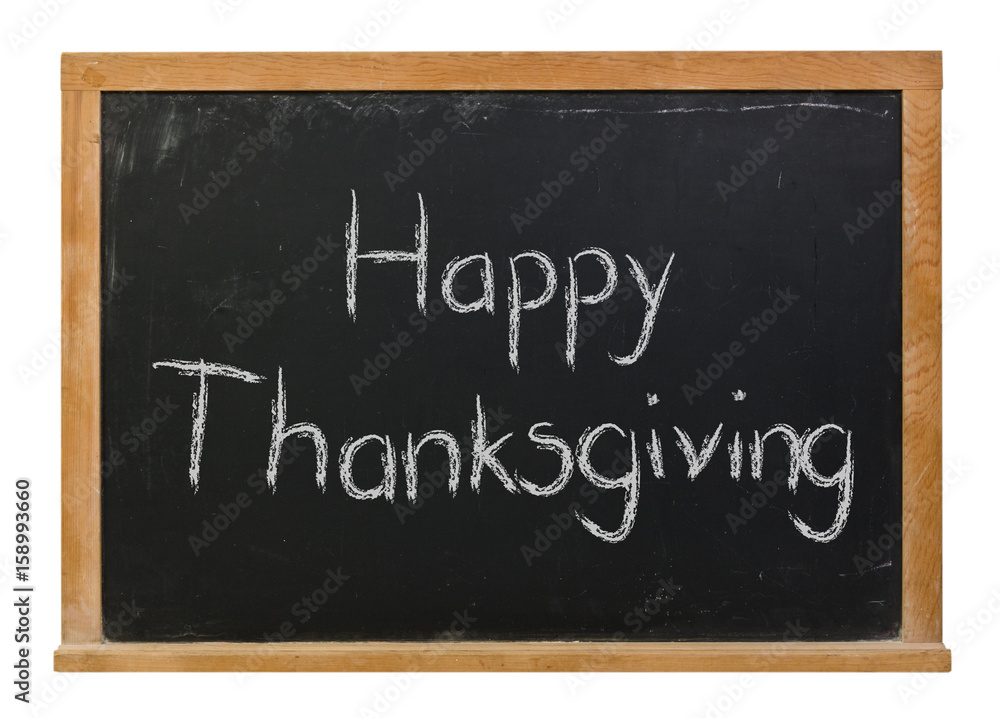 Happy Thanksgiving written in white chalk on a black chalkboard isolated on white Happy Thanksgiving written in white chalk on a black chalkboard isolated on white
