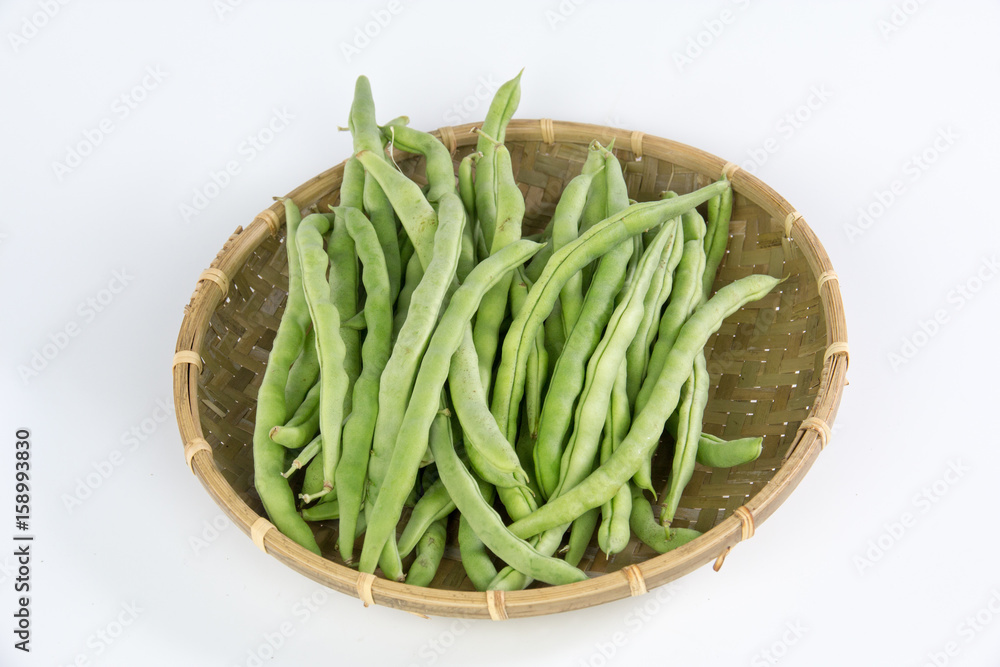 Green bean in a bamboo basket isolated on white background Green bean in a bamboo basket isolated on white background