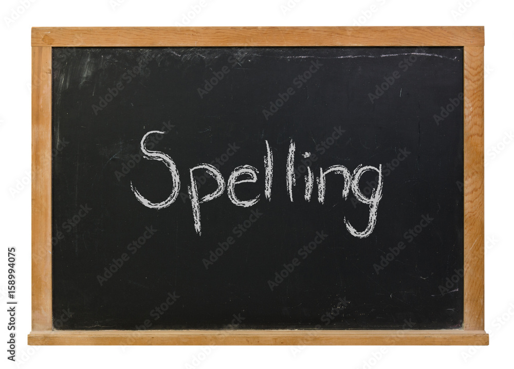 Spelling written in white chalk on a black chalkboard isolated on white Spelling written in white chalk on a black chalkboard isolated on white