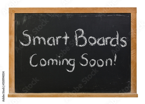 Smart boards coming soon written in white chalk on a black chalkboard isolated on white