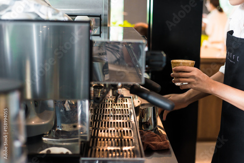 Barista hand make baverage from coffee machine in coffee shop