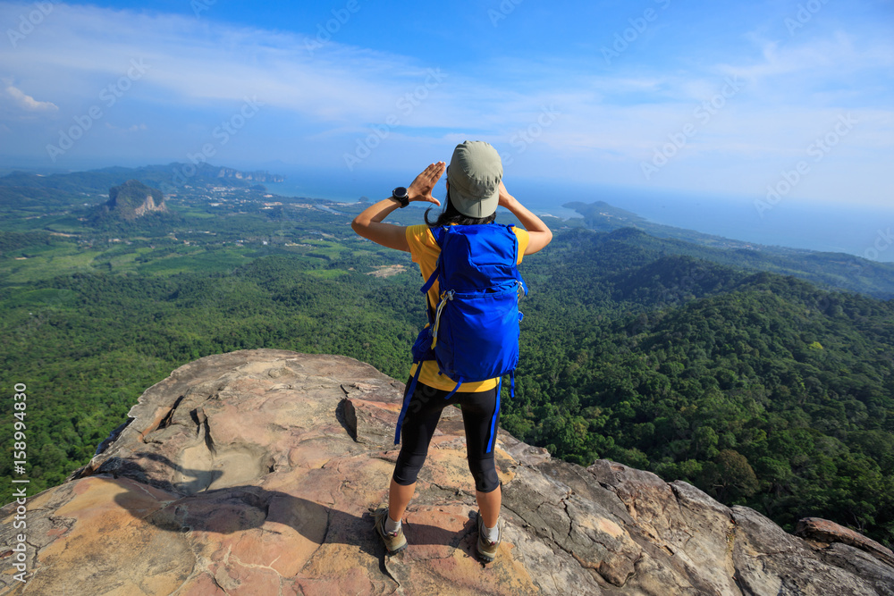 woman traveler with backpack hiking summer vacations outdoor beautiful seaside mountains on background