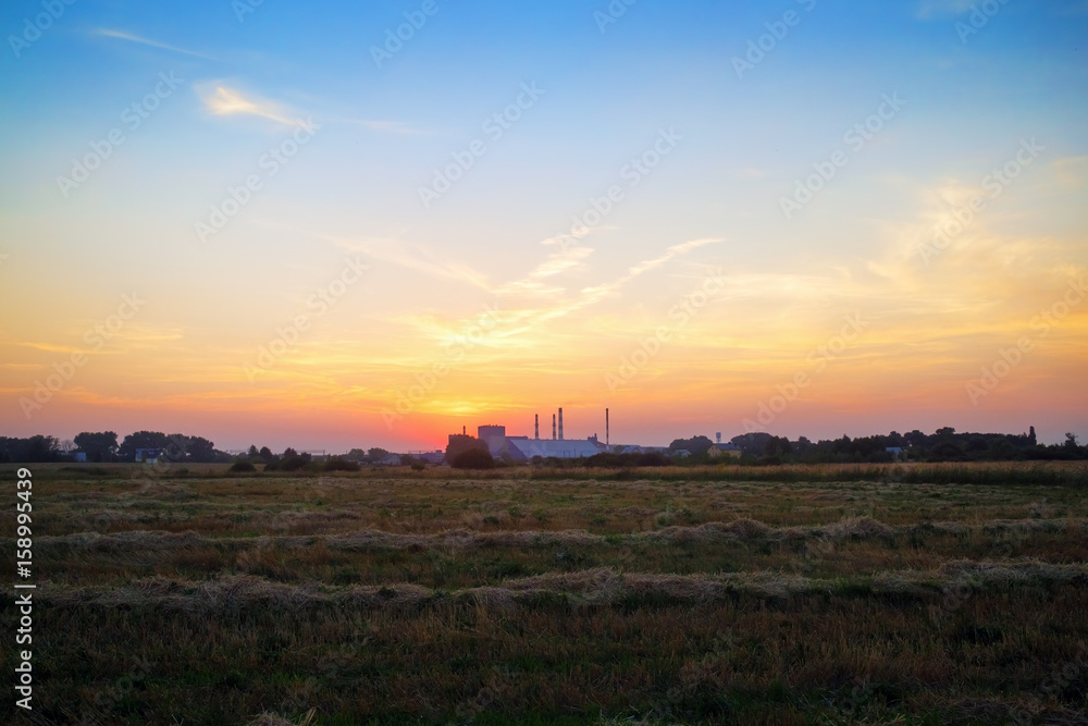 Beautiful sunset. Sun rays in the picturesque sky and rural meadow. Beautiful sunset. Sun rays in the picturesque sky and rural meadow.