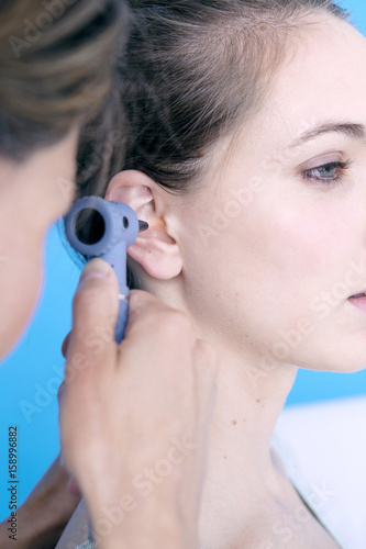 Doctor examining the ear of a patient