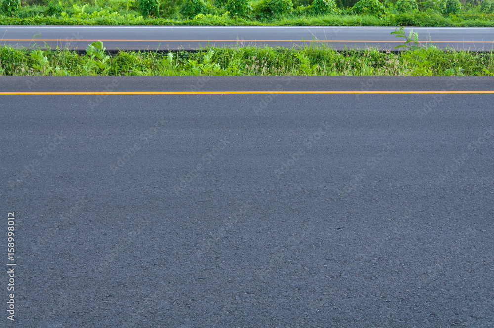 Empty highway with dividing line, roadside and green grass, abstract transportation background,asphalt road new construction Empty highway with dividing line, roadside and green grass, abstract transportation background,asphalt road new construction