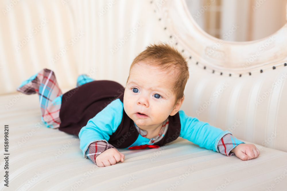 Portrait of a cute newborn baby lying on its stomach and smiling Portrait of a cute newborn baby lying on its stomach and smiling