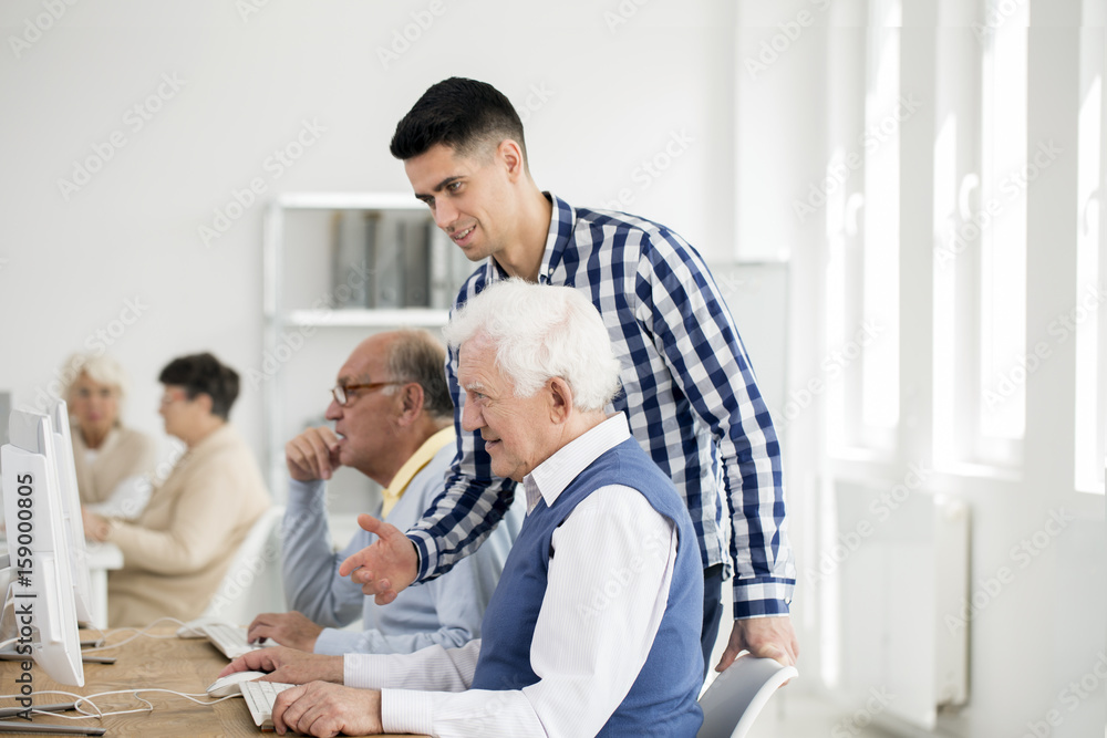 Man checking senior's progress Man checking senior's progress