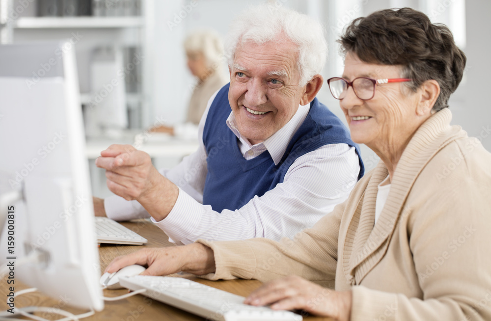 Senior man pointing at screen Senior man pointing at screen