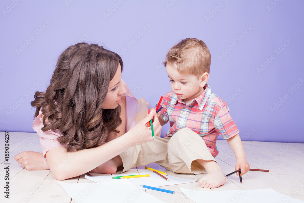 mother and young son play paint crayons mother and young son play paint crayons