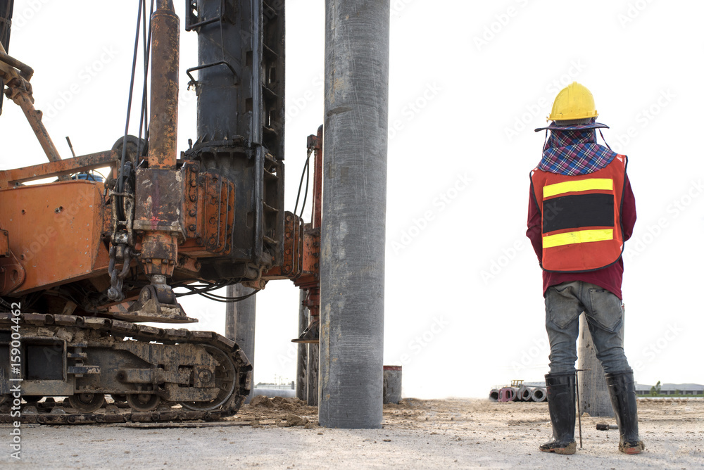 engineer or construction worker stand checking last ten blows in foundation construction work heavy equipment machine background engineer or construction worker stand checking last ten blows in foundation construction work heavy equipment machine background
