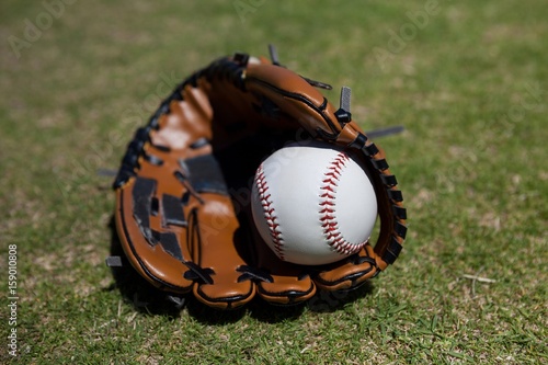 Baseball and glove on field