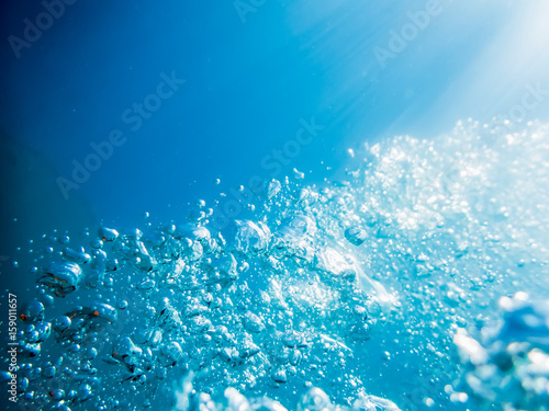 Underwater blue ocean texture. Bubbles in tropical sea.