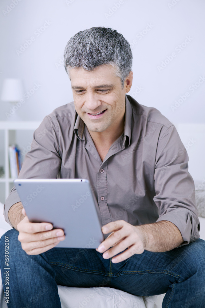 Man using tablet computer Man using tablet computer