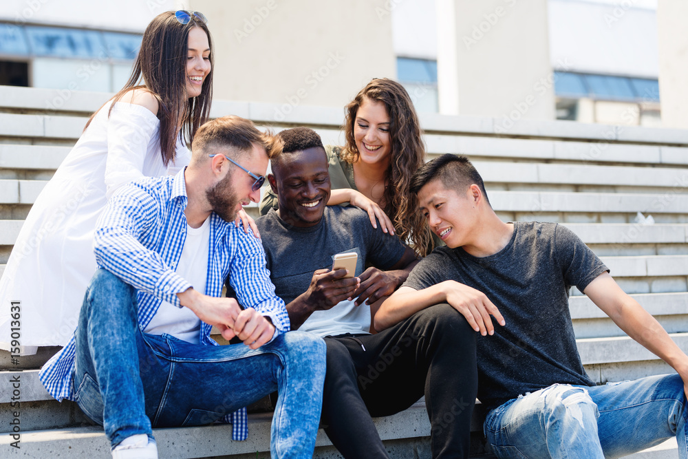 Friends hanging out in front of school Stock-Foto | Adobe Stock