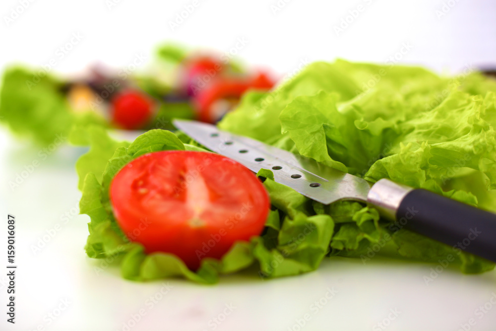 Fresh vegetables with a knife on the table for salad preparation Fresh vegetables with a knife on the table for salad preparation