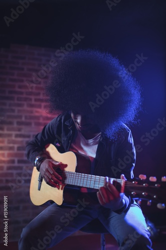 Male guitarist performing at music concert