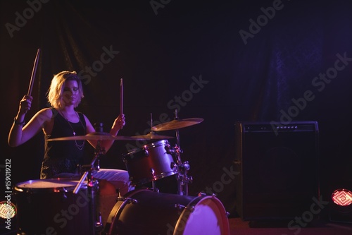 Female drummer performing in nightclub