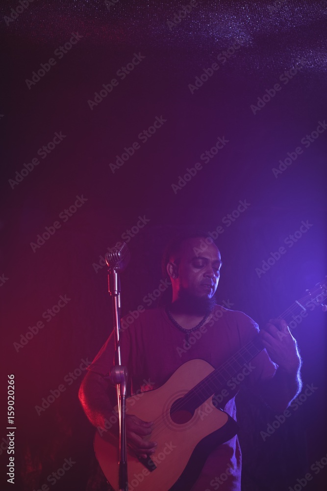 Male guitarist performing in concert