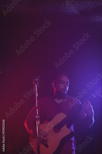 Male guitarist performing in concert