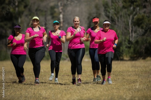Group of women jogging together in the boot camp
