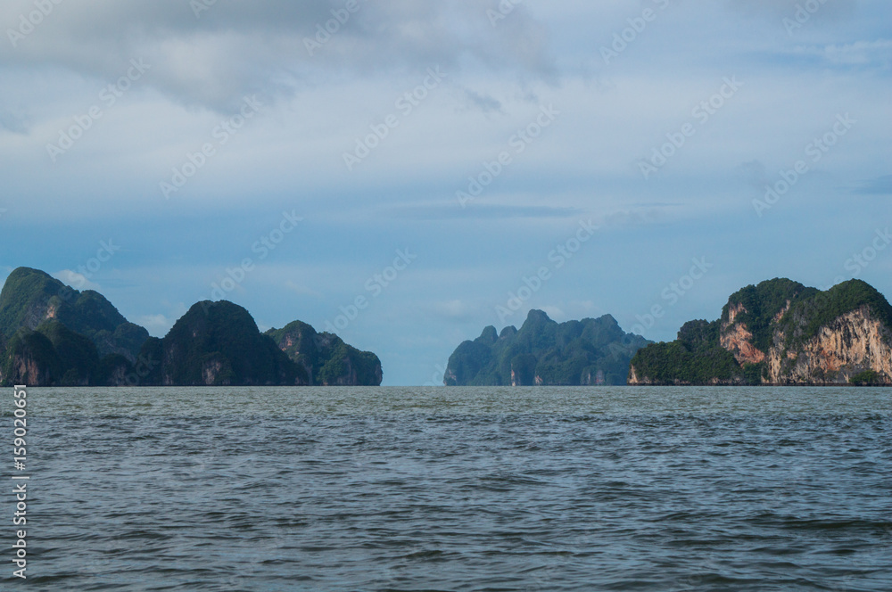 Limestone karsts rising out of the bay Limestone karsts rising out of the bay