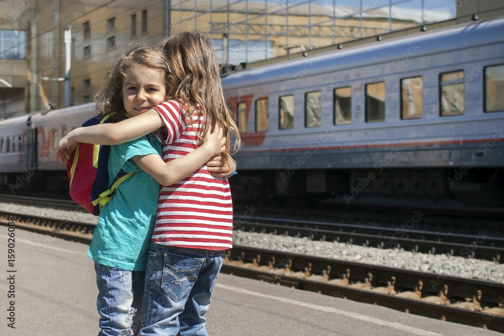 Hot embrace of happy sisters after a long separation at the station Hot embrace of happy sisters after a long separation at the station