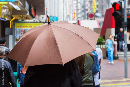 person with rain umbrella in the city
