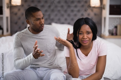 Obraz na płótnie Young couple arguing while sitting at home
