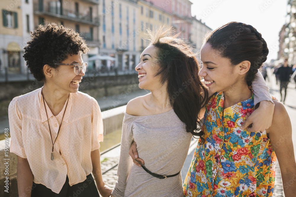 Black affectionate female friends having fun in the city Black affectionate female friends having fun in the city