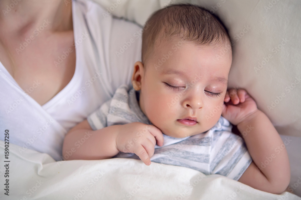 baby sleeps next to mom in the big parental bed baby sleeps next to mom in the big parental bed