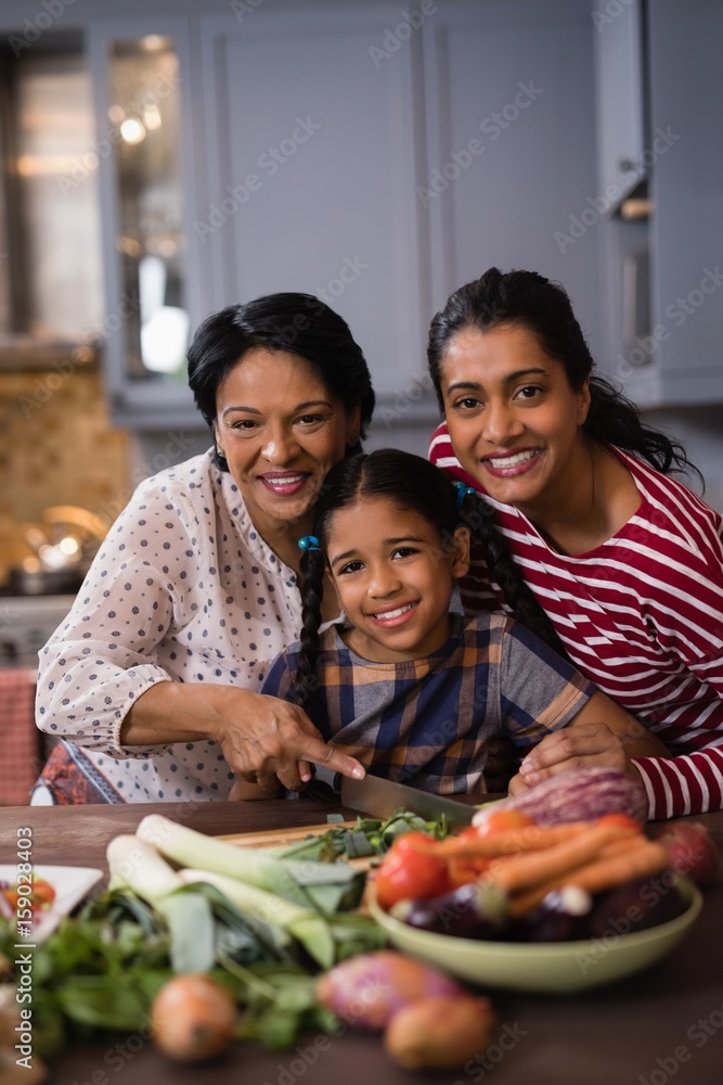 Portrait of multi-generation family preparing food 