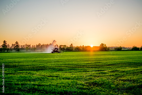 water pump at sunset in a big green field Europe © Archmotion.net