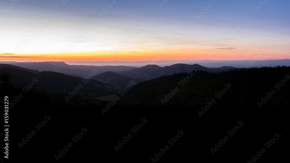 French countryside. Sunrise in the Vosges with a view of the Rhine valley and the Black Forest (Germany) in the background.