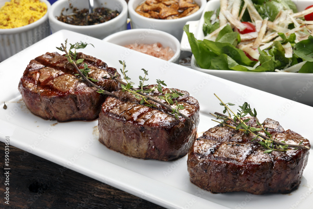Three steaks roasted on the grill Three steaks roasted on the grill
