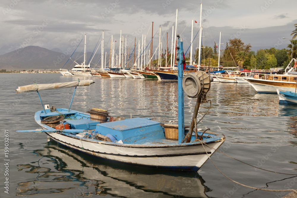 Fototapeta premium Unnamed boats in the ancient harbor of Fethiye, (Hisaronu, Turkey)Turkey, in Lycia on the coast of Mediterranean