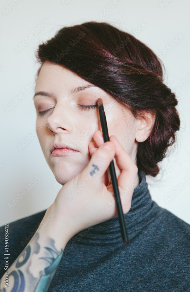 Beautiful woman in her twenties having make up applied Beautiful woman in her twenties having make up applied