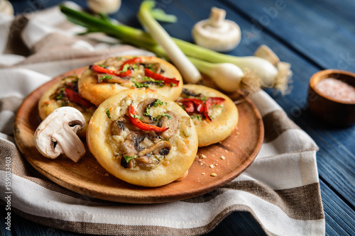 Baked small mushroom pies with cheese and pepper