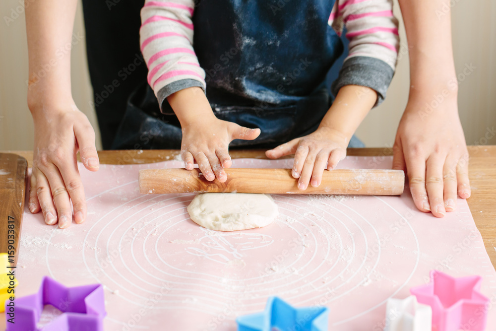 Mother and toddler girl making cookies Mother and toddler girl making cookies